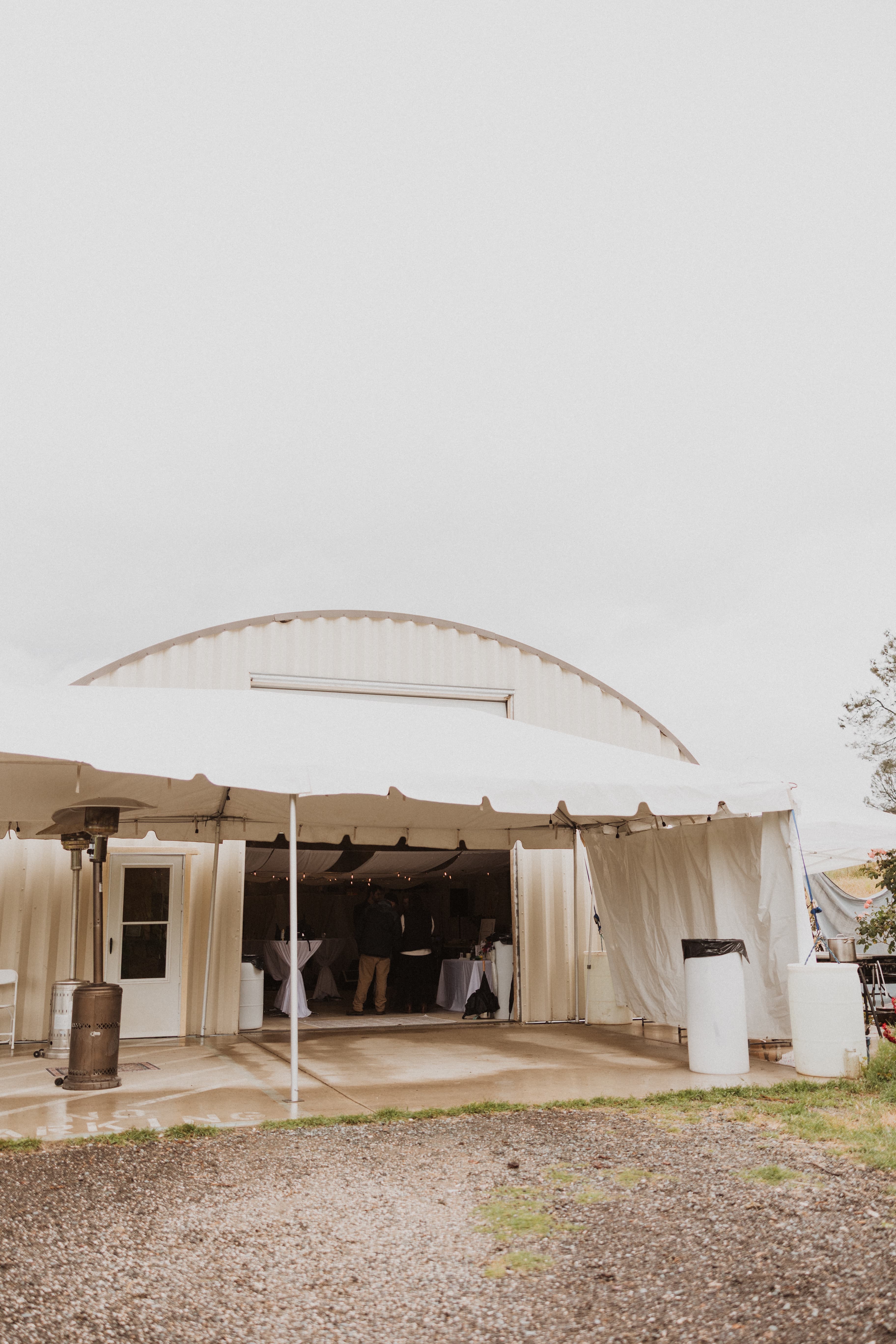 Wide view of event tent and quonset hut